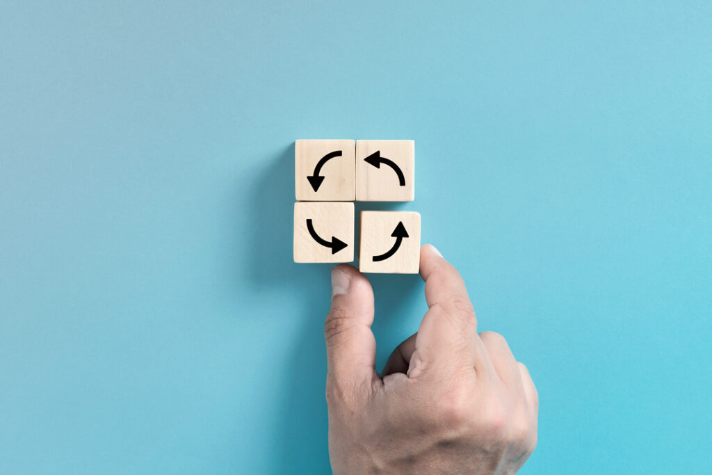 Blocks with rotating arrows printed on them represent corporate travel program flexibility.