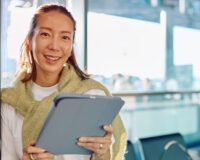 Traveler using a modern business travel platform on a tablet