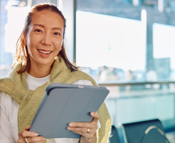 Traveler using a modern business travel platform on a tablet