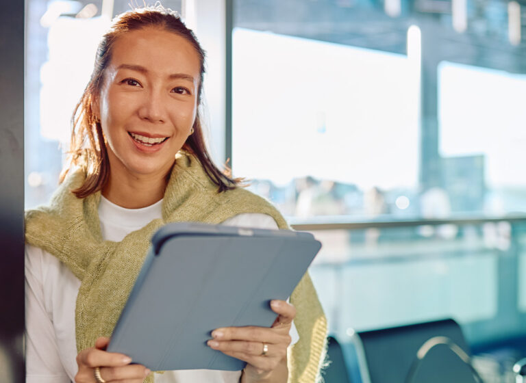Traveler using a modern business travel platform on a tablet
