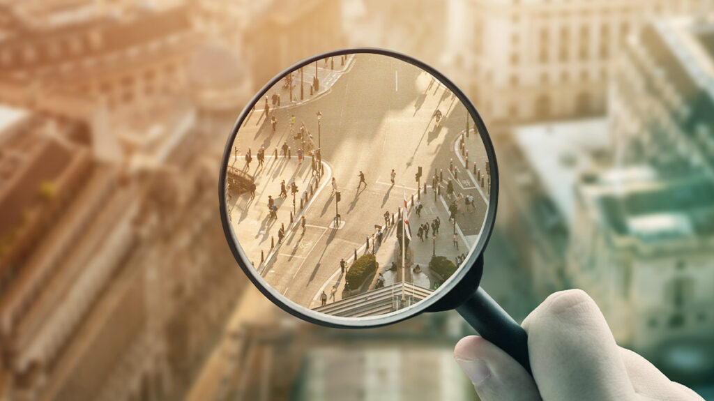 Image of a magnifying glass enlarging a street intersection - duty of care business travel risks