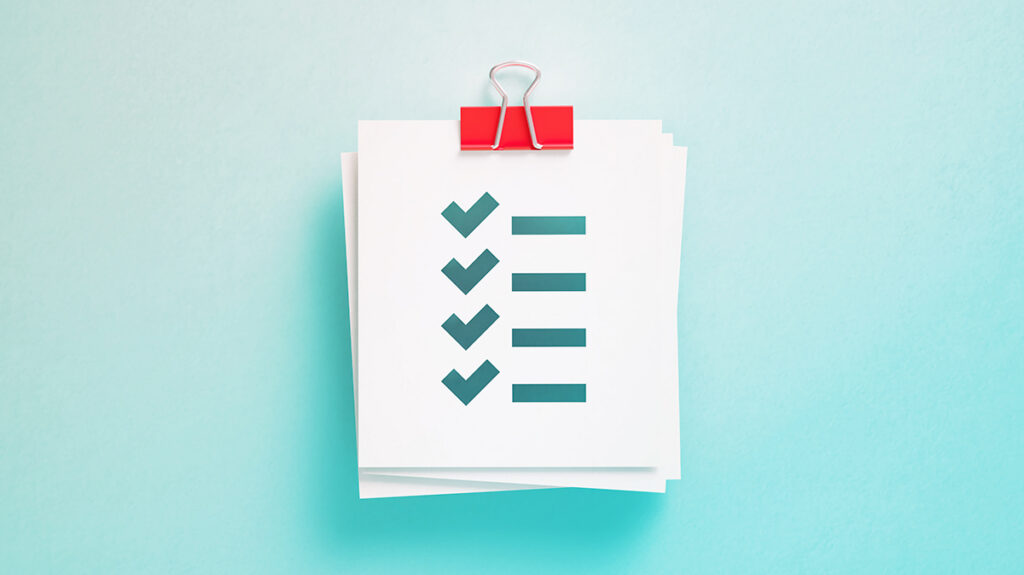 A piece of paper with a checklist graphic showing humans should review AI